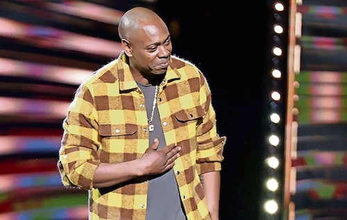 dave chappelle in a yellow shirt
